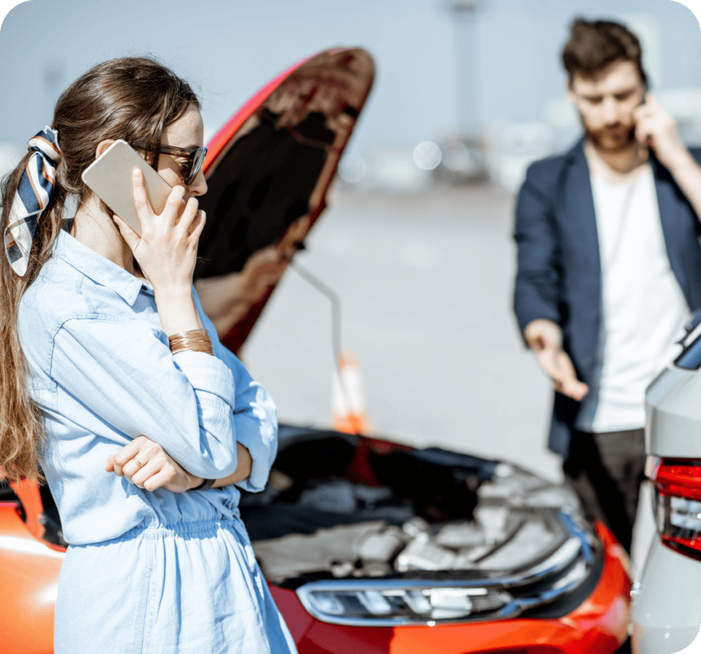 Man and woman on cell phones after car accident