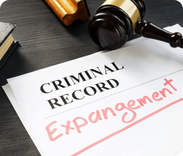 a gavel and criminal record document with "expungement" written on it
