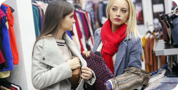 two ladies shoplifting in a fashion store