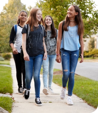 four girls walking along the walk way