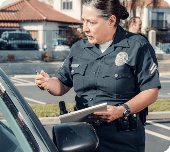 a policewoman speaking to a car driver