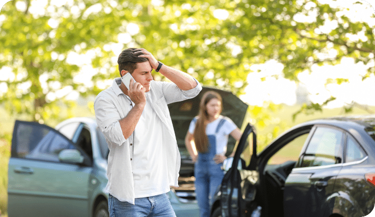 a person on their phone after a car accident